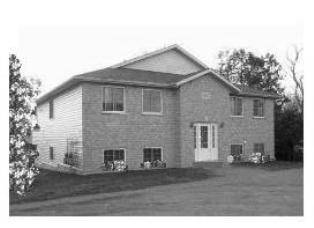 Four plex apartment building with four separate apartments, black and white picture