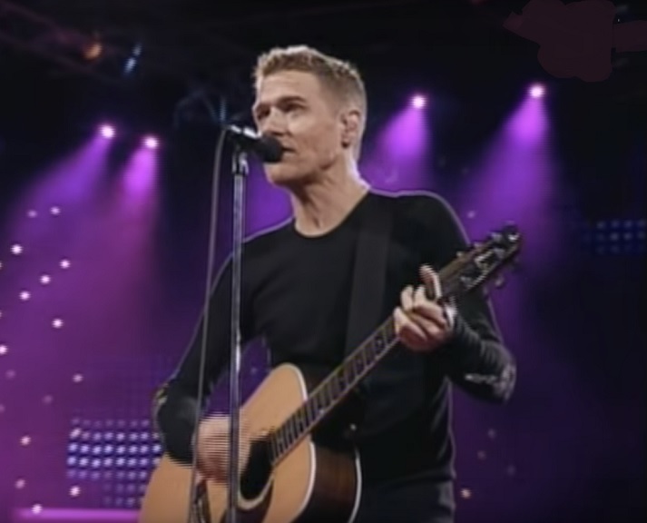 Bryan Adams on stage with guitar