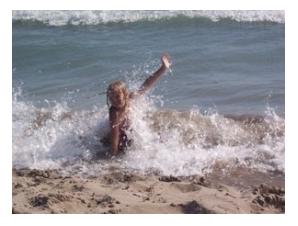Small blonde child being splashed by waves, Lake Erie, Port Stanley, Ontario, 2005