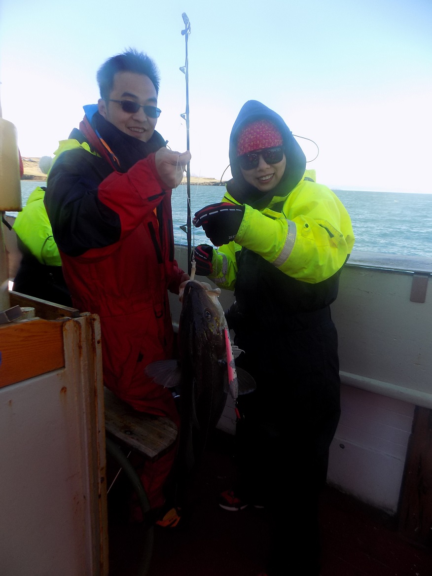 two tourists catching cod, Iceland, whale watching boat trip 2017