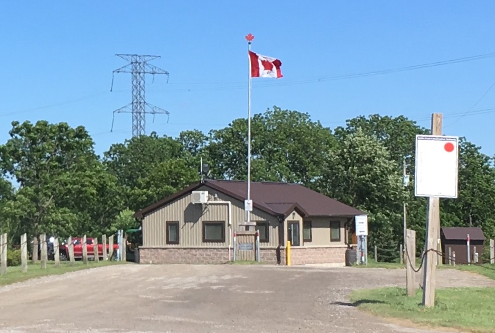 the gatehouse at Dalewood Conservation Area flying Canadian flag