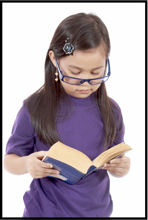 homeschooling girl with purple shirt and glasses reading a book